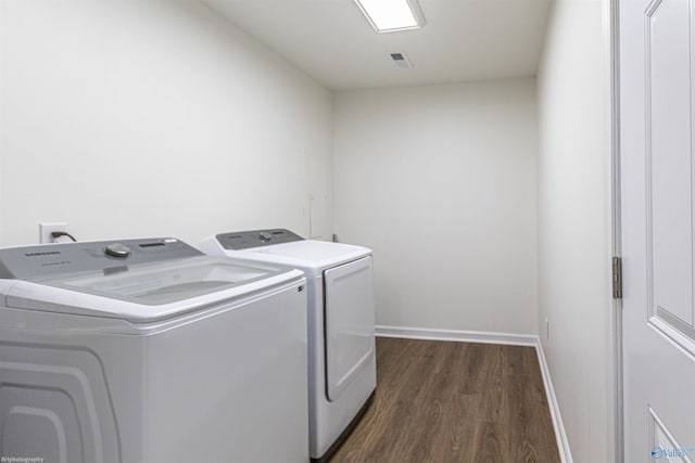 laundry room with washer and clothes dryer and dark hardwood / wood-style floors