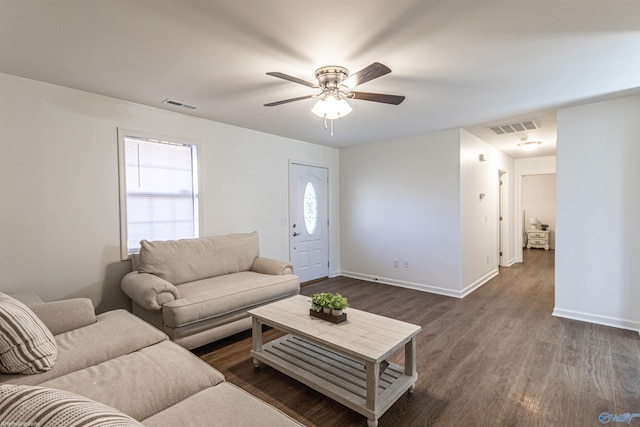 living room with dark hardwood / wood-style flooring and ceiling fan