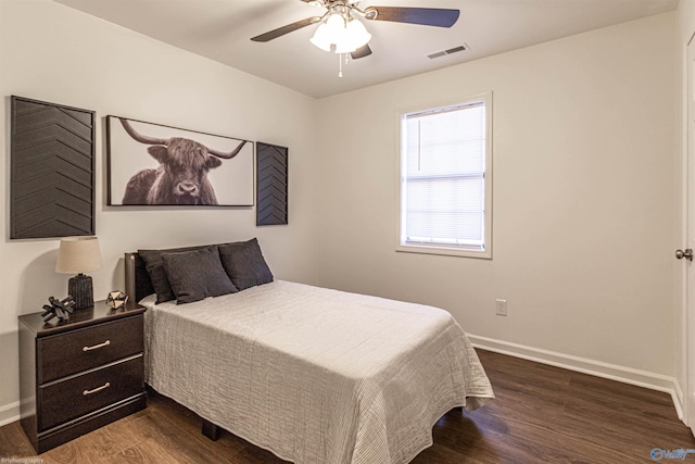 bedroom with ceiling fan and dark hardwood / wood-style floors