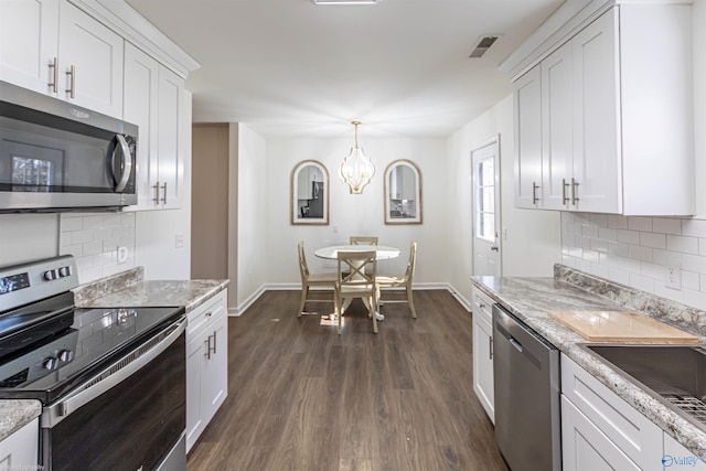 kitchen featuring dark hardwood / wood-style floors, stainless steel appliances, decorative backsplash, and white cabinets