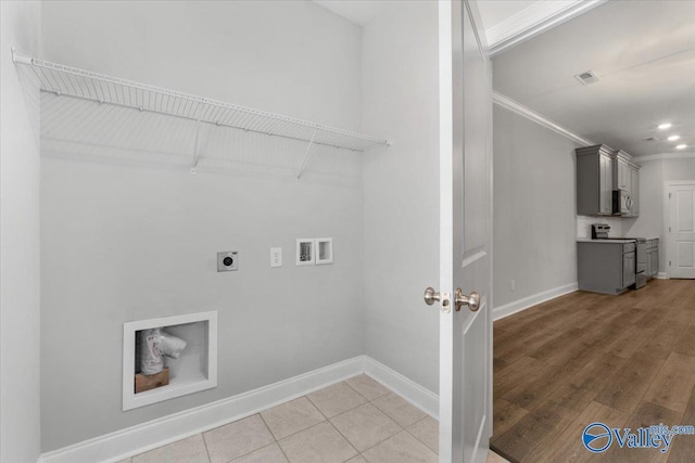 washroom featuring hookup for an electric dryer, hardwood / wood-style floors, hookup for a washing machine, and crown molding