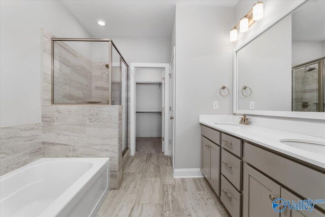 bathroom with vanity and independent shower and bath