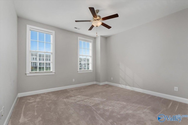 unfurnished room with light carpet, plenty of natural light, and ceiling fan