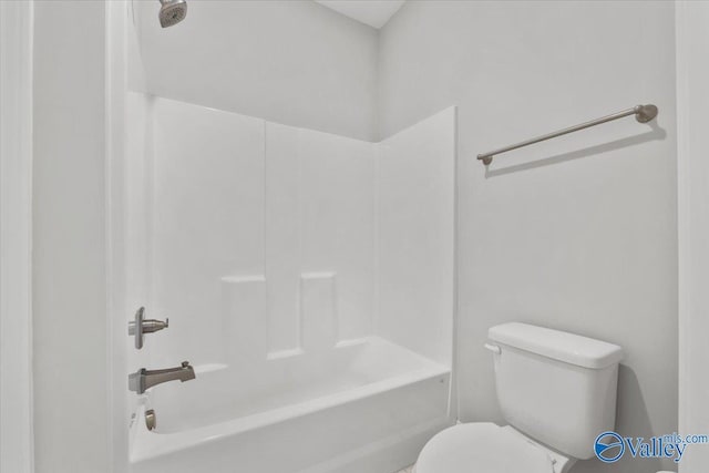 bathroom featuring washtub / shower combination and toilet