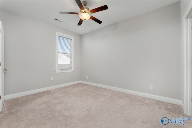 spare room featuring ceiling fan and light carpet