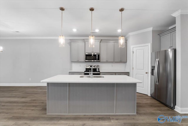 kitchen featuring stainless steel appliances, hanging light fixtures, gray cabinetry, and sink