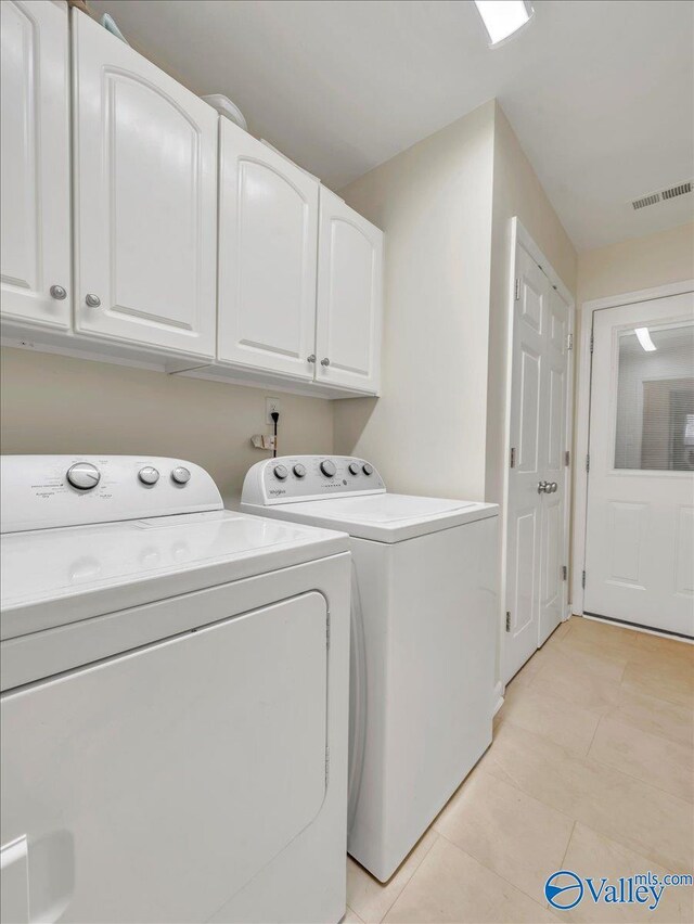 986 Tracey Ln, Decatur, AL 35601 - washroom with cabinet space, washer and dryer, and light tile patterned floors