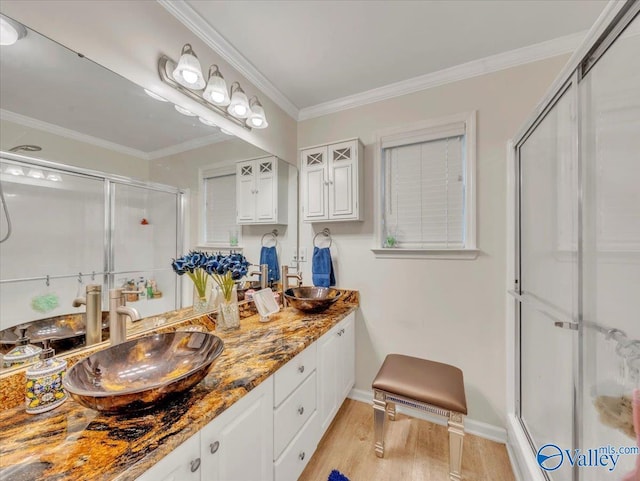 986 Tracey Ln, Decatur, AL 35601 - full bath featuring a shower stall, wood finished floors, double vanity, baseboards, and crown molding