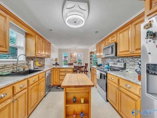 986 Tracey Ln, Decatur, AL 35601 - kitchen featuring appliances with stainless steel finishes, a sink, butcher block countertops, a peninsula, and decorative backsplash