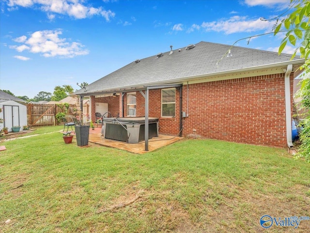 986 Tracey Ln, Decatur, AL 35601 - rear view of property with a hot tub, brick siding, a patio, and a shingled roof