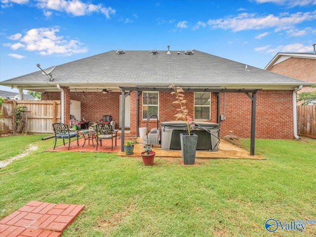 986 Tracey Ln, Decatur, AL 35601 - rear view of property featuring a hot tub, a patio, brick siding, and roof with shingles