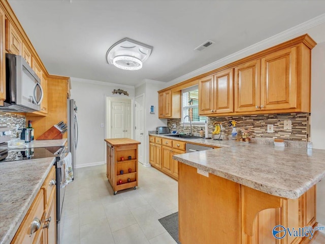 986 Tracey Ln, Decatur, AL 35601 - kitchen with stainless steel appliances, a sink, tasteful backsplash, a peninsula, and butcher block counters