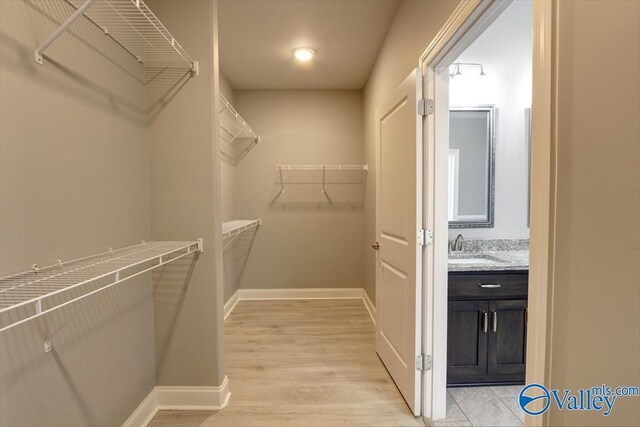 26415 Birkshire Ln, Athens, AL 35613 - spacious closet with light wood-style flooring and a sink