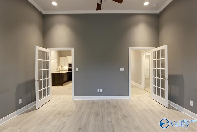 26415 Birkshire Ln, Athens, AL 35613 - spare room featuring french doors, ornamental molding, ceiling fan, baseboards, and light wood-type flooring