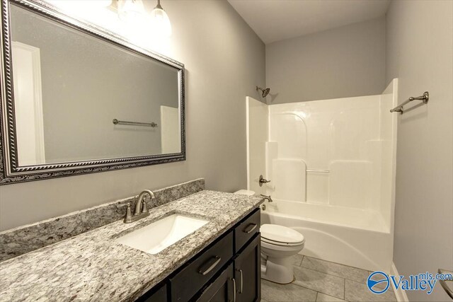 26415 Birkshire Ln, Athens, AL 35613 - bathroom featuring toilet, vanity,  shower combination, and tile patterned flooring