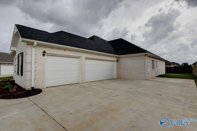 26415 Birkshire Ln, Athens, AL 35613 - view of side of home featuring driveway, a garage, roof with shingles, brick siding, and stone siding