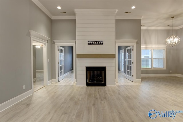 26415 Birkshire Ln, Athens, AL 35613 - unfurnished living room with ornamental molding, a chandelier, a fireplace, wood finished floors, and baseboards
