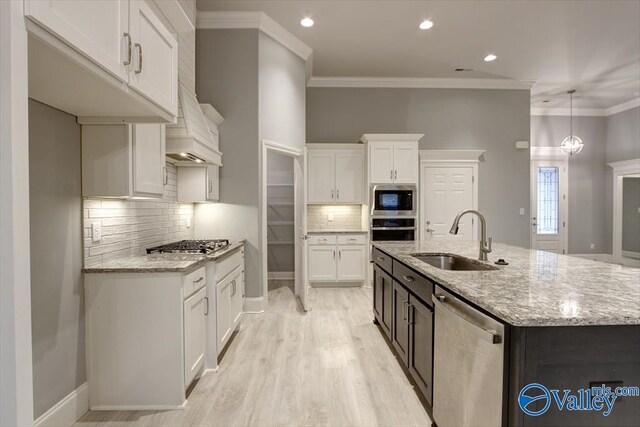 26415 Birkshire Ln, Athens, AL 35613 - kitchen with stainless steel appliances, a sink, white cabinetry, decorative backsplash, and ornamental molding