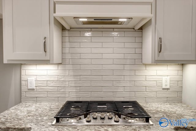 26415 Birkshire Ln, Athens, AL 35613 - kitchen with stainless steel gas cooktop, tasteful backsplash, light stone counters, and white cabinetry
