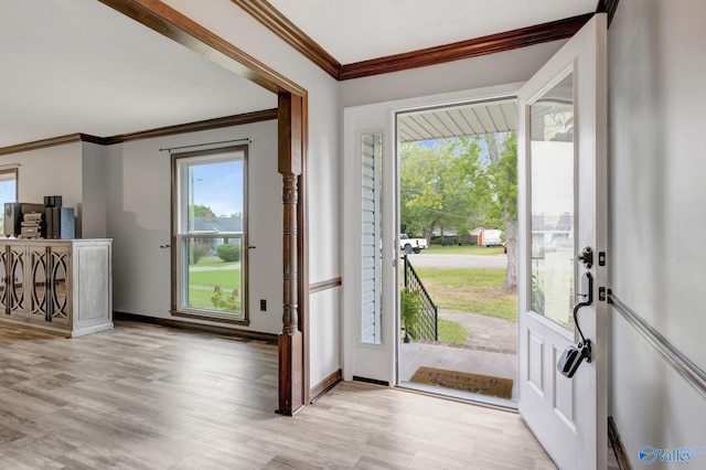 entrance foyer featuring light hardwood / wood-style floors and ornamental molding