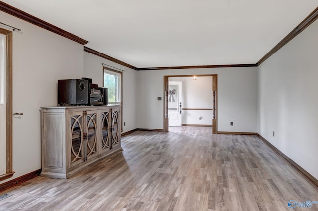 unfurnished living room with crown molding and light wood-type flooring