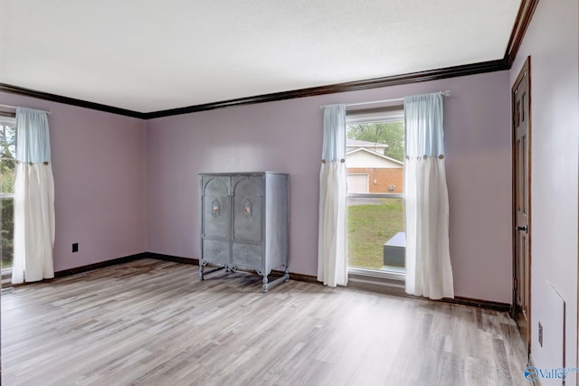 unfurnished room with crown molding and light hardwood / wood-style flooring