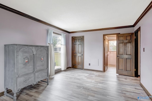 interior space with light hardwood / wood-style floors and ornamental molding