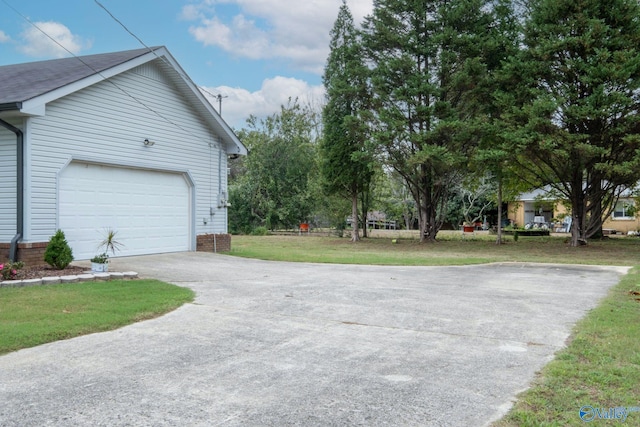 garage featuring a lawn