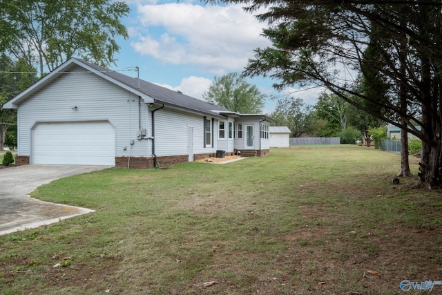 view of side of home with a lawn and a garage