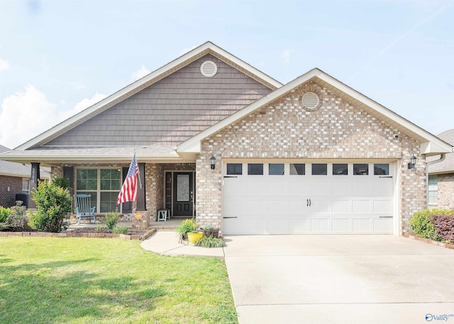 craftsman-style house with brick siding, driveway, a front yard, and a garage