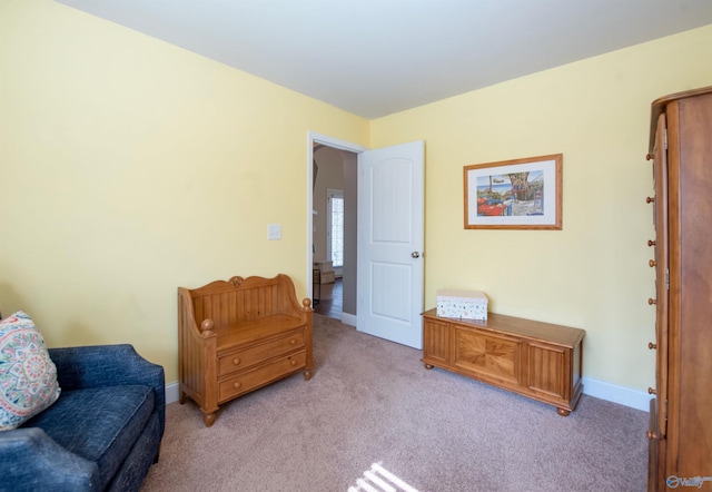 sitting room with light colored carpet and baseboards