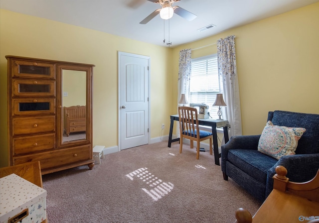 sitting room featuring visible vents, carpet flooring, baseboards, and ceiling fan