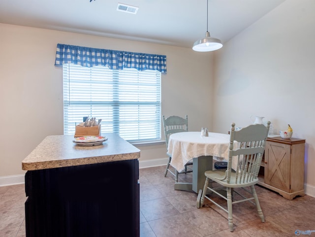 dining room with baseboards, visible vents, and a healthy amount of sunlight