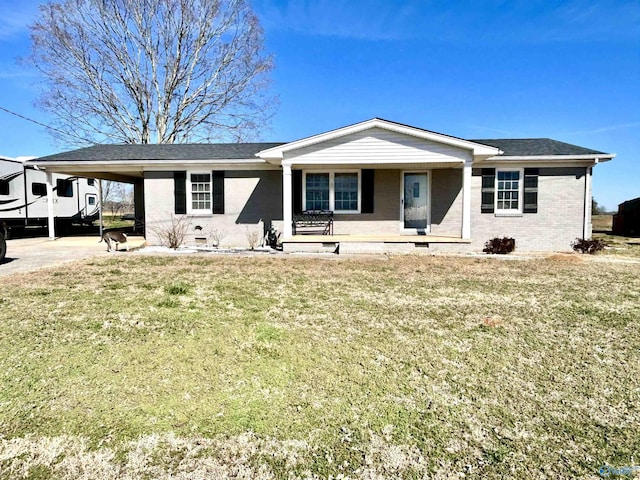 view of front facade with crawl space, brick siding, a carport, and a front yard