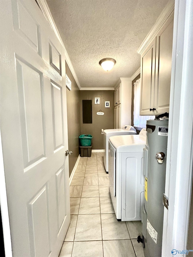 washroom with crown molding, cabinet space, electric water heater, a textured ceiling, and washer and dryer