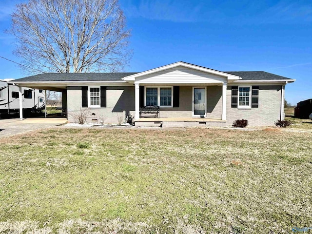 ranch-style home featuring brick siding, an attached carport, crawl space, covered porch, and a front yard