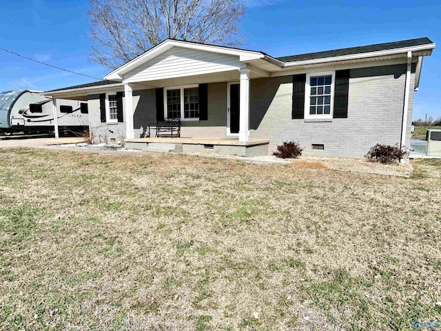 ranch-style house featuring a porch, an attached carport, brick siding, crawl space, and a front yard