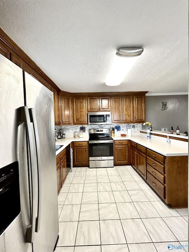 kitchen featuring stainless steel appliances, brown cabinetry, light countertops, and crown molding