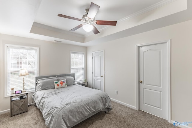 bedroom with crown molding, light colored carpet, a raised ceiling, and ceiling fan