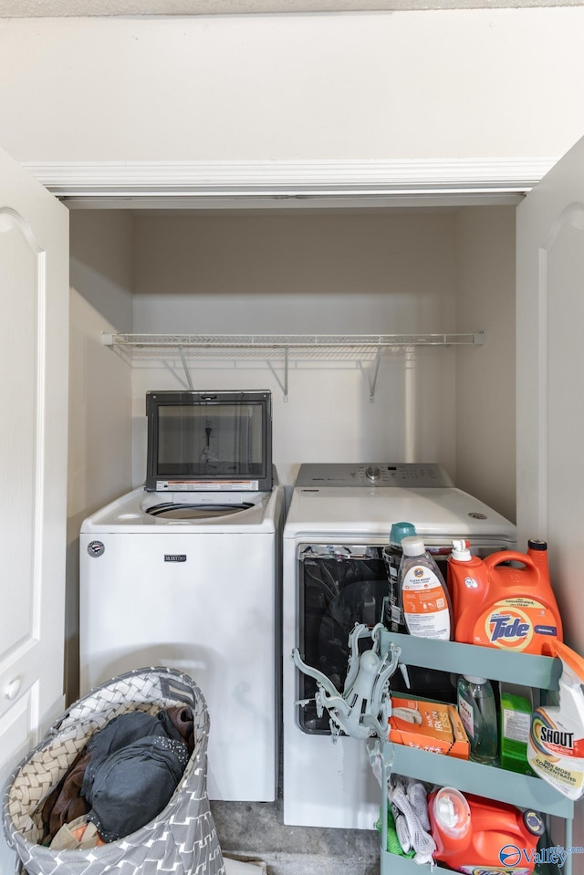 clothes washing area with washing machine and dryer