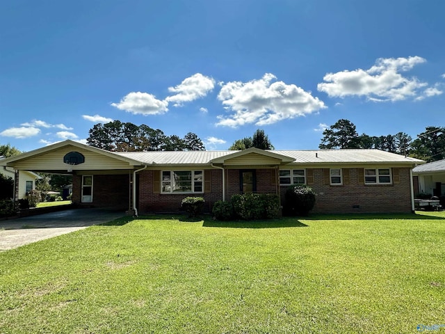 ranch-style home with a front lawn, a carport, concrete driveway, metal roof, and brick siding