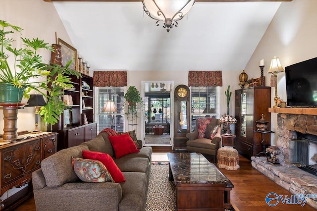 living room with dark hardwood / wood-style floors, a stone fireplace, and lofted ceiling