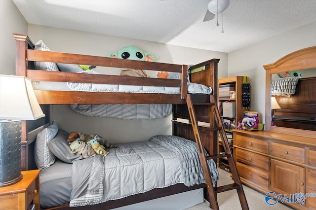 bedroom with light carpet, ceiling fan, and a textured ceiling