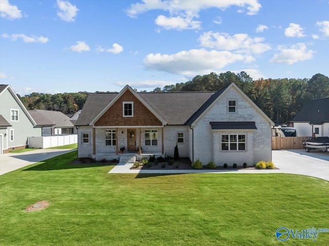 view of front of property featuring covered porch and a front yard