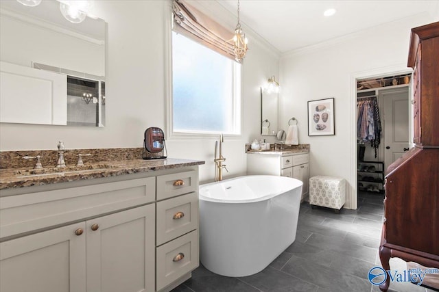 bathroom with a washtub, vanity, and ornamental molding