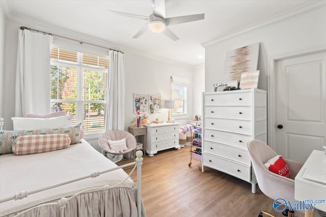 bedroom featuring hardwood / wood-style floors, ceiling fan, and crown molding