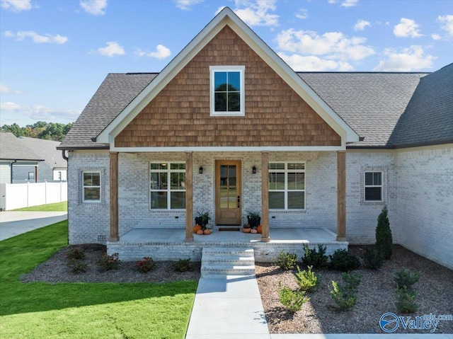 view of front of property featuring covered porch and a front yard