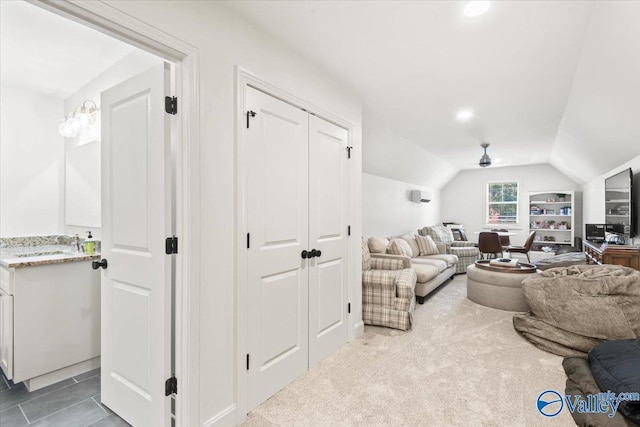 living room featuring carpet, ceiling fan, lofted ceiling, and sink