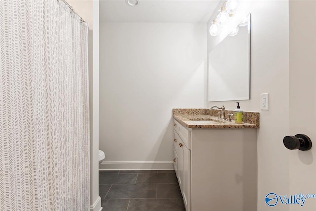 bathroom with tile patterned floors, vanity, and toilet