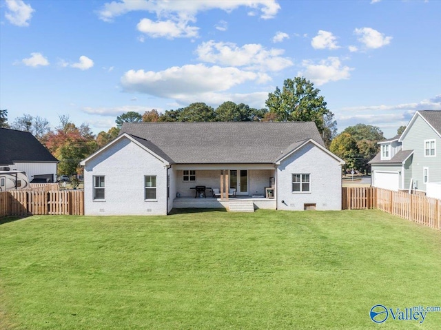 back of property featuring a yard and a patio